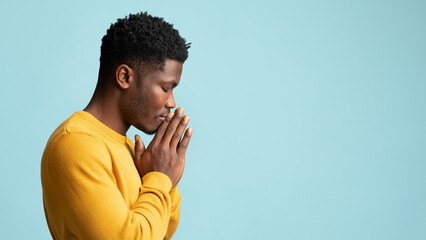 A man with his eyes closed praying